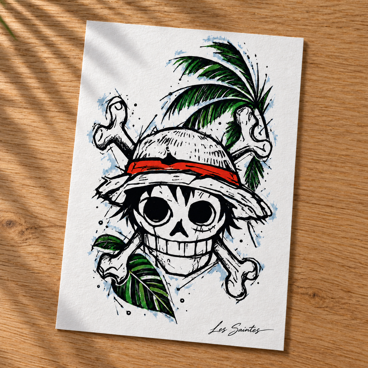 Carte postale — Pirate tropical, papier texturé posé sur une table avec une légère ombre de feuillage — Atelier Karaïbes, Les Saintes — fan art Luffy (One Piece)